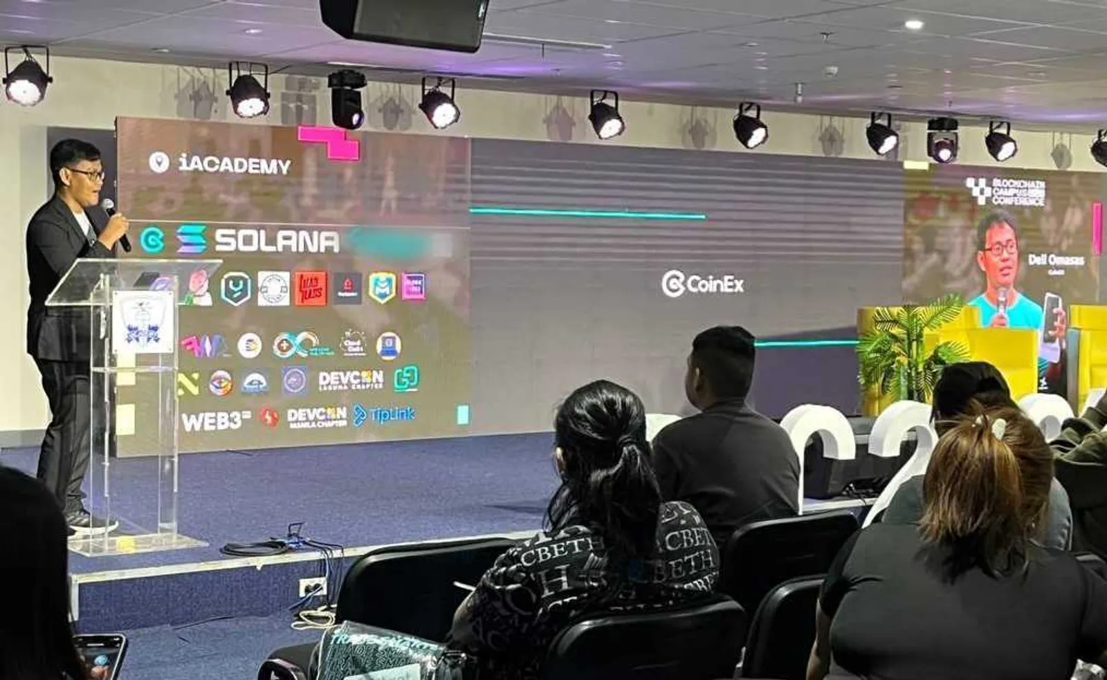 CoinEx Charity booth at event with students engaging.